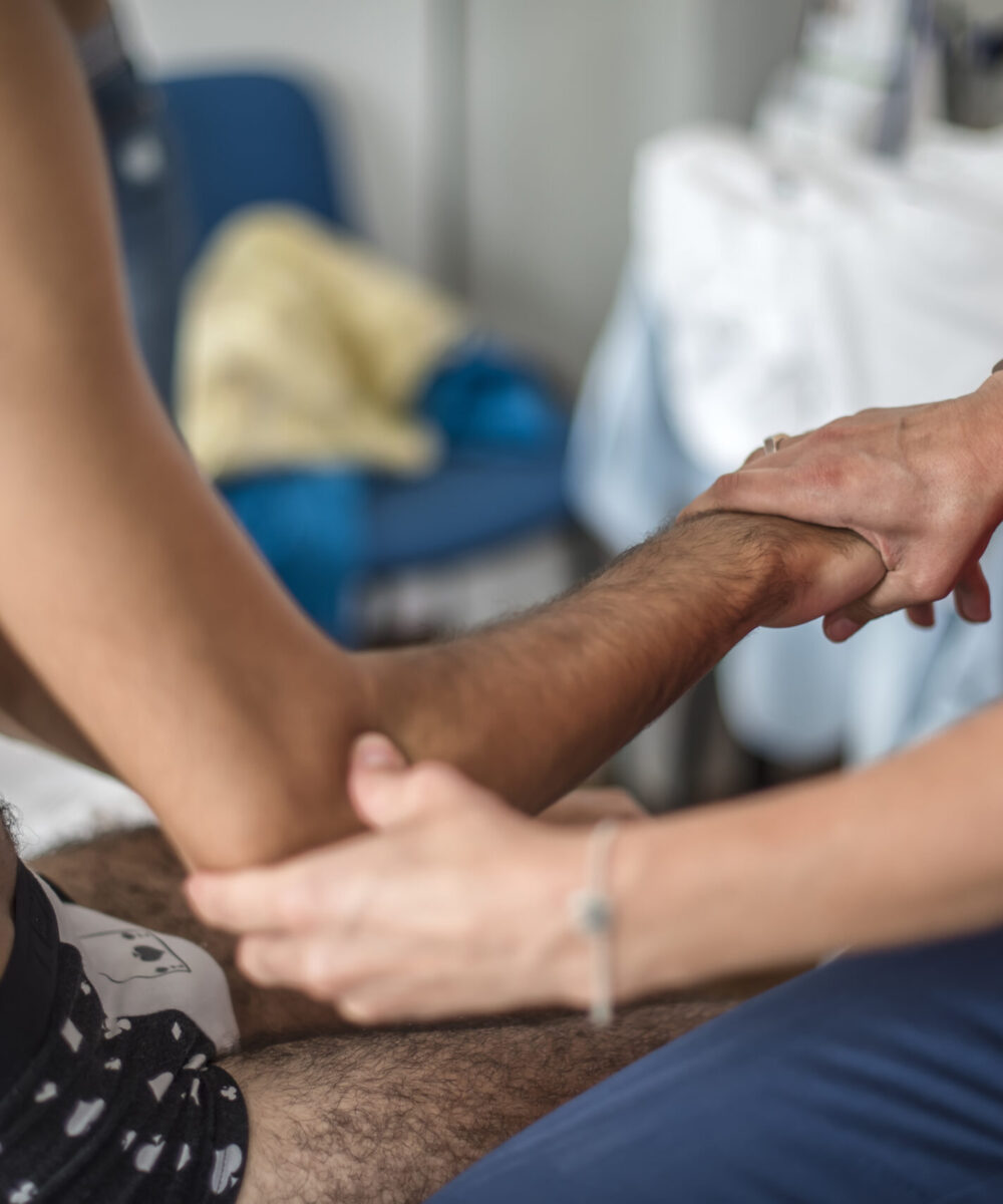 therapist-assists-patient-with-arm-rehabilitation-2026-03-09-04-07-48-utc